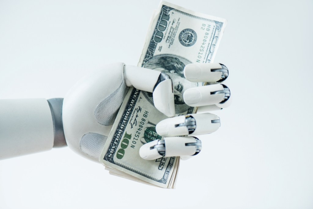 Robot grasping money - profits of robotics and AI
